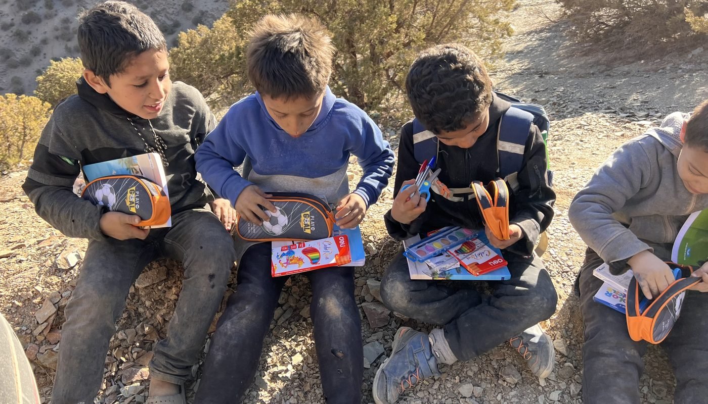 Children in Morocco’s High Atlas opening newly delivered school supplies — pencils, paints and notebooks